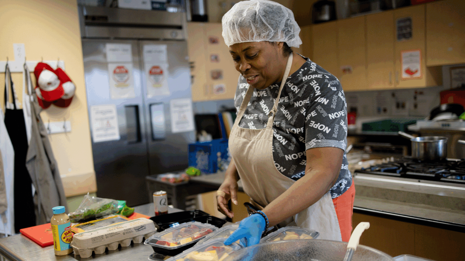 Black woman cooking in a commercial kitchen